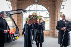 Pall bearers outside a crematorium